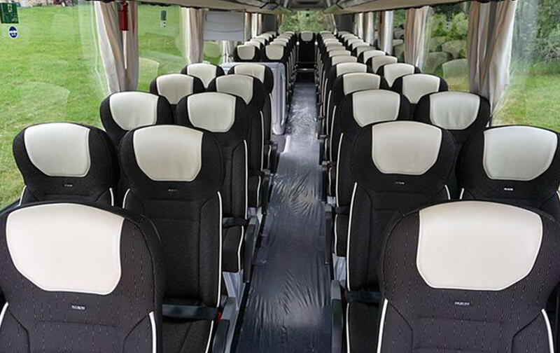 Full-size coach interior with reclining seats and aisle